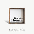 Wooden frame with 'Be a nice Human' text on a white background