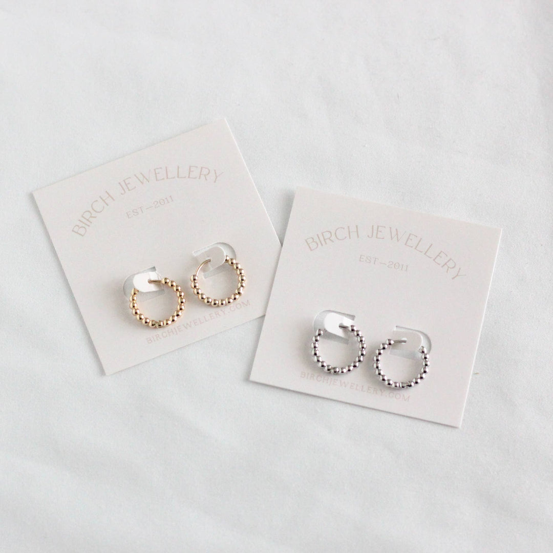 Pair of hoop earrings on Birch Jewellery branded cards against a light background