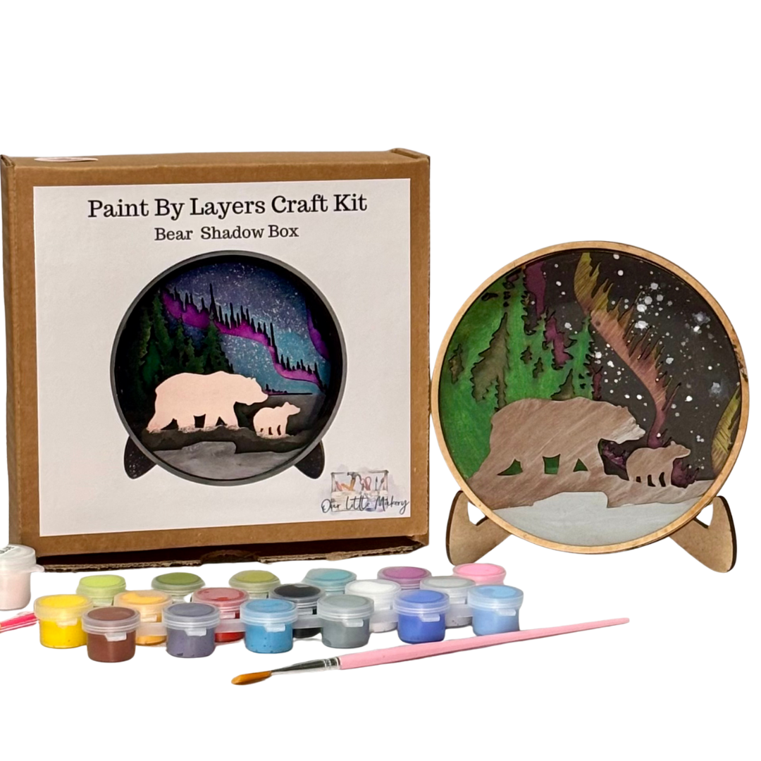Paint by layers craft kit with bear shadow box design, paint cans, and brush on a white background