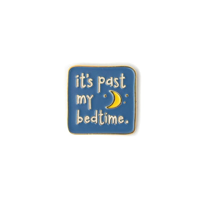 Enamel pin with 'it's past my bedtime' text and moon symbol on a blue background
