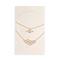 A pair of gold necklaces on a white card. The longer necklace features a honeycomb pendant, and the shorter necklace features a bee pendant. The card has the text 