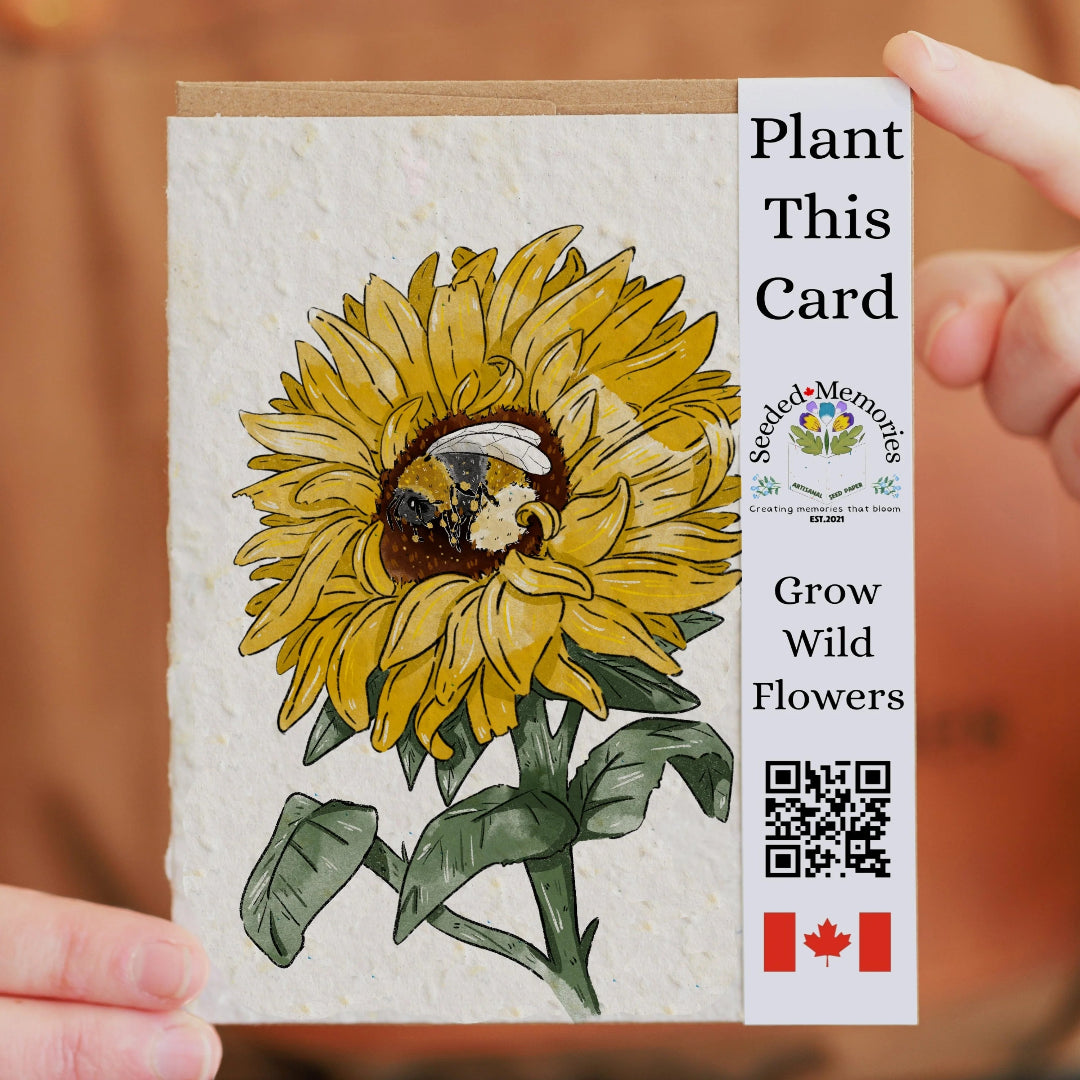 Card with sunflower design and 'Plant This Card' text, held by a person.