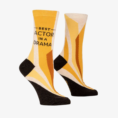 A pair of women's crew socks with a vibrant design of yellow and orange rays emanating from the bottom. Text on one sock reads 
