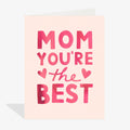 Greeting card with 'Mom you're the best' text on a light pink background