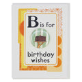 Greeting card with a button featuring a birthday cake illustration and text 'B is for birthday wishes' on a decorative background.