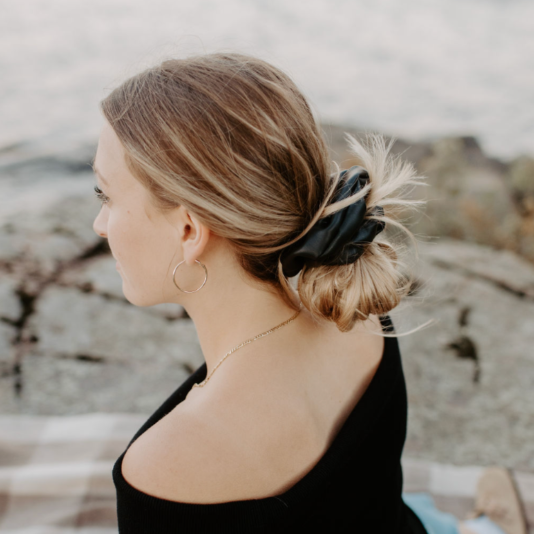 Woman sitting outdoors with a scenic background