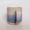 A handmade ceramic mug with a blue ombre glaze, featuring a speckled texture, displayed on a light gray background. The mug has a large, rounded handle and is made in Mississippi Mills, Ontario, Canada.