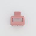 Pink rectangular hair clip on a white background
