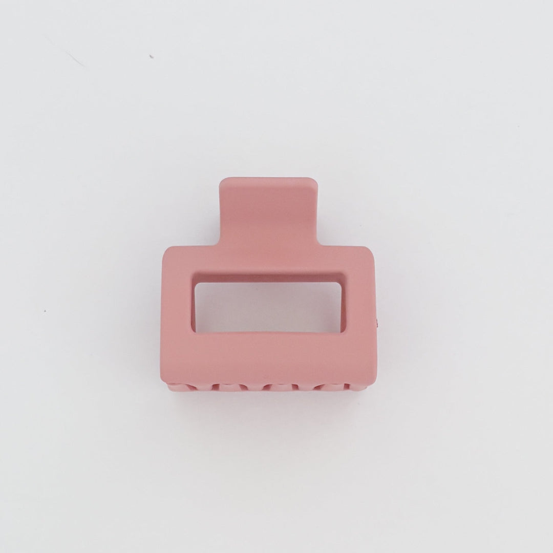 Pink rectangular hair clip on a white background