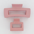 Two pink rectangular hair clips on a white background