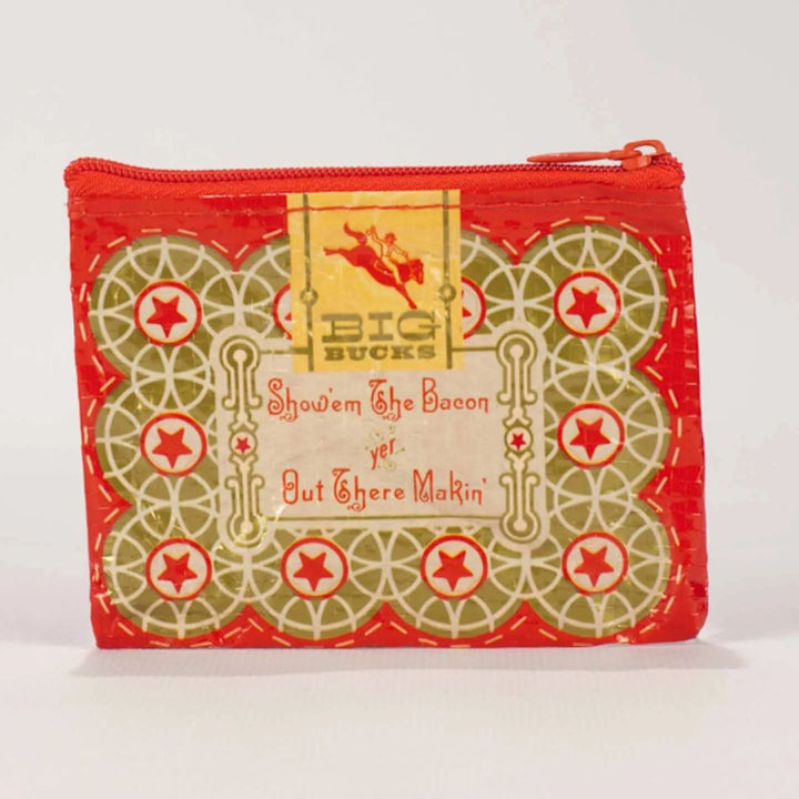 A small red coin purse with a zipper, featuring a vintage-style illustration of a woman riding a horse with a triumphant pose. The text 