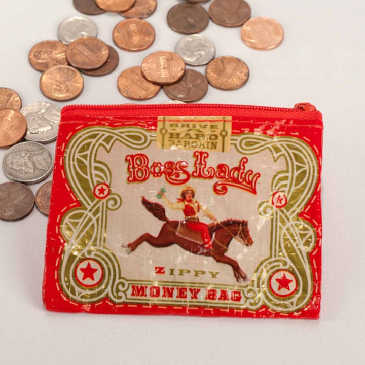 A small red coin purse with a zipper, featuring a vintage-style illustration of a woman riding a horse with a triumphant pose. The text 