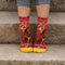 A pair of red ankle socks with yellow accents. One sock features a vintage-style illustration of a cowgirl riding a horse, with 