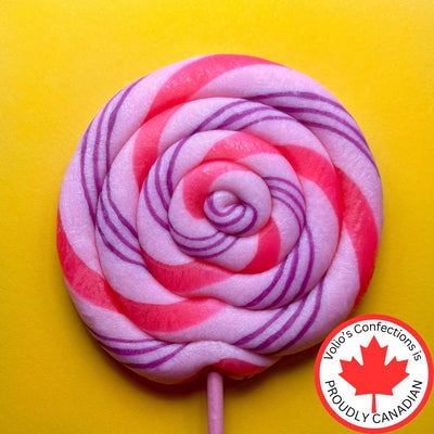 Pink and purple striped lollipop on a yellow background with Jolly's Confections proudly Canadian logo.