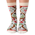 Socks with a Christmas design featuring reindeer and trees on a white background