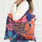 A colorful tote bag with a floral pattern and the text 