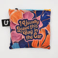A colorful tote bag with a floral pattern and the text "I Usually Leave This Bag In The Car." The bag has a bright orange handle.