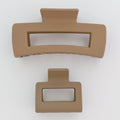 Two brown hair clips on a white background