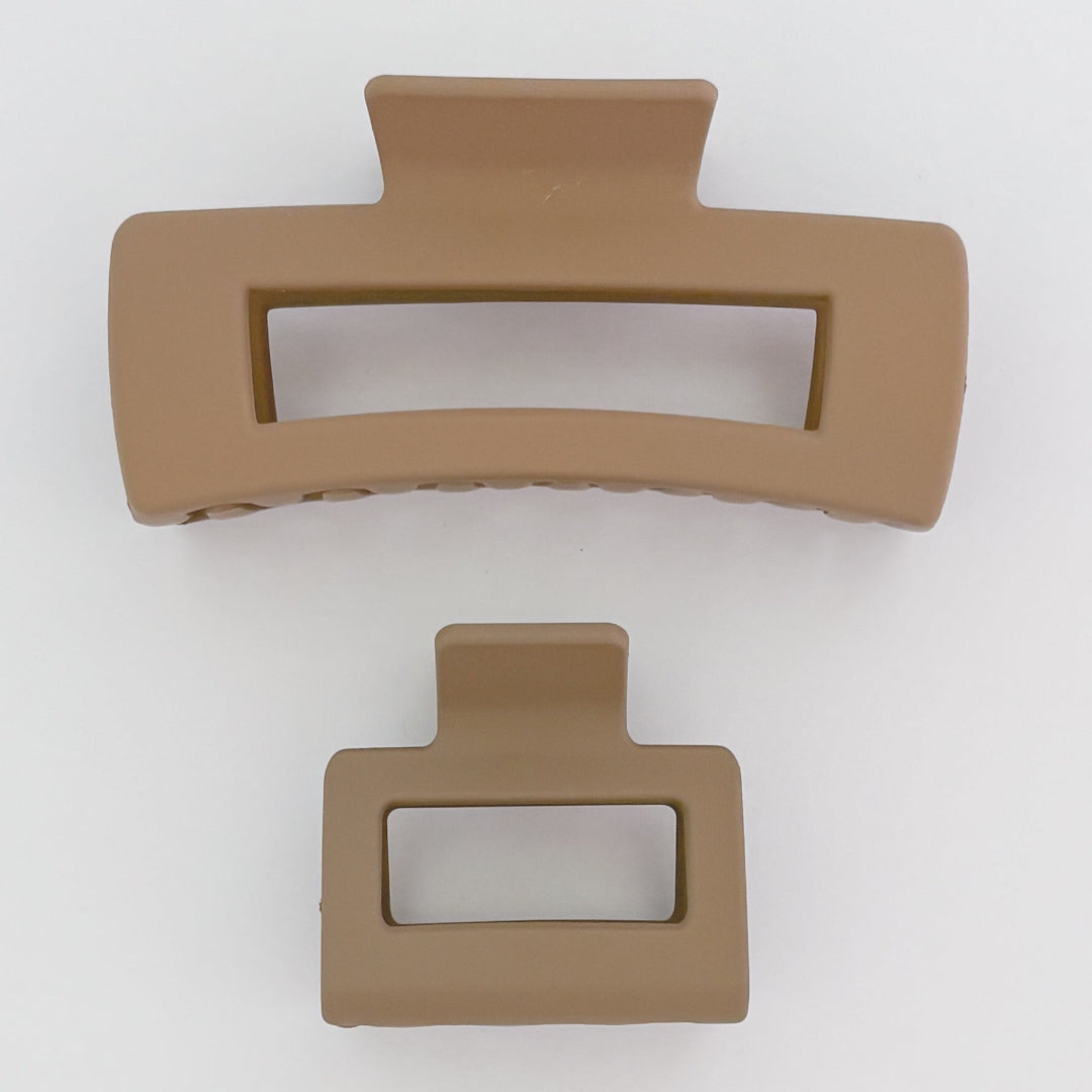 Two brown hair clips on a white background