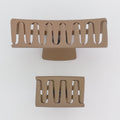 Two beige hair clips on a white background