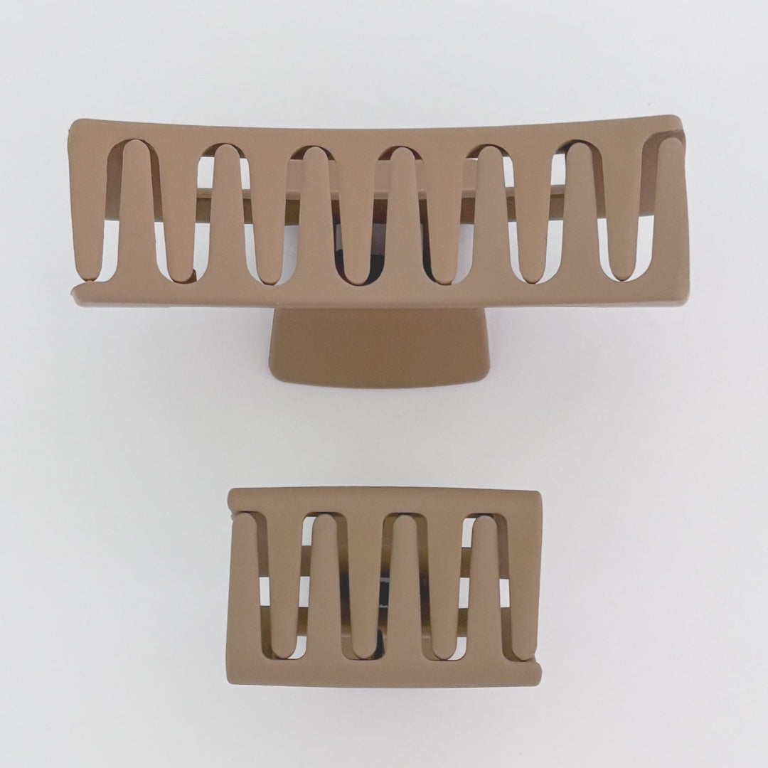 Two beige hair clips on a white background