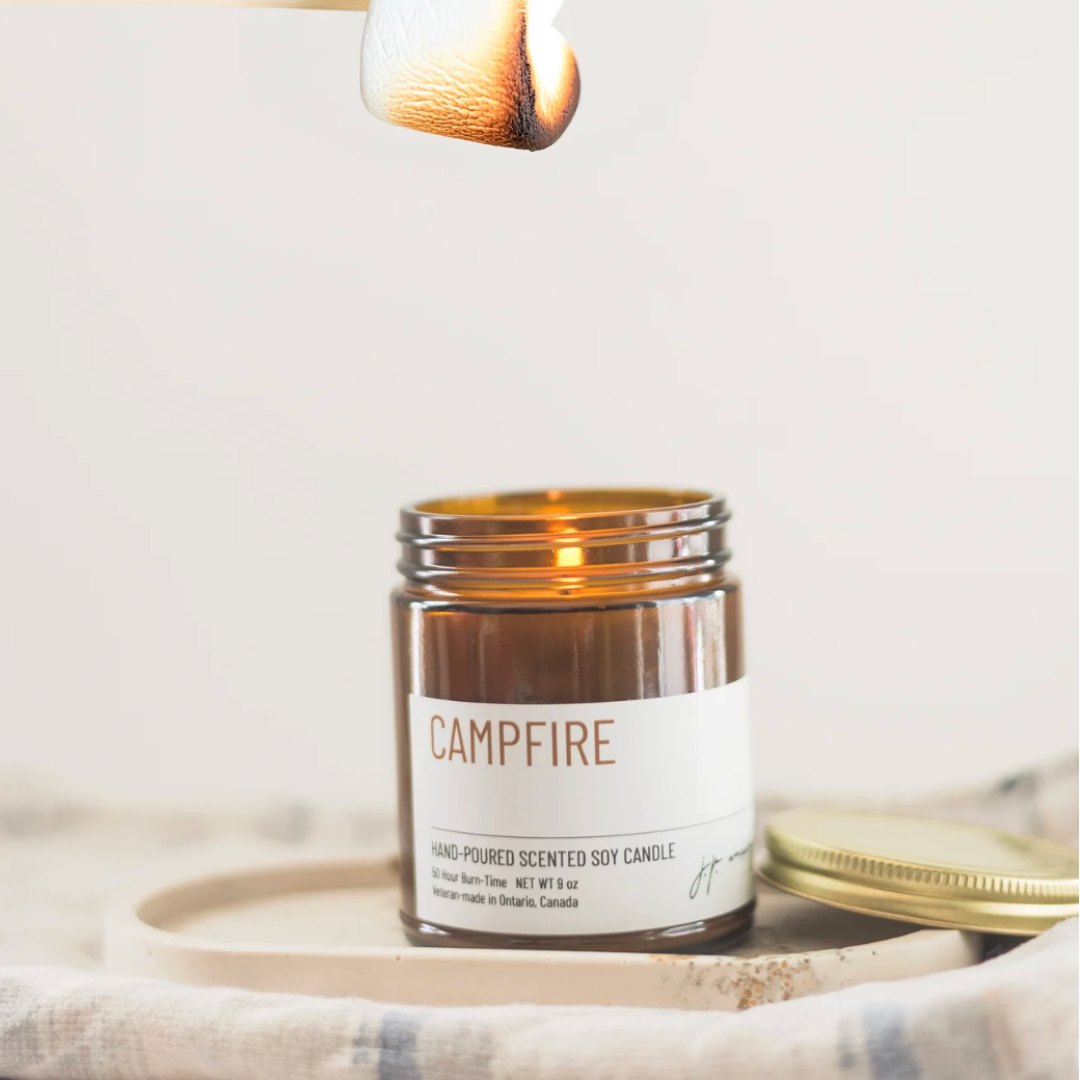 Campfire scented candle jar with a wooden wick on a light background