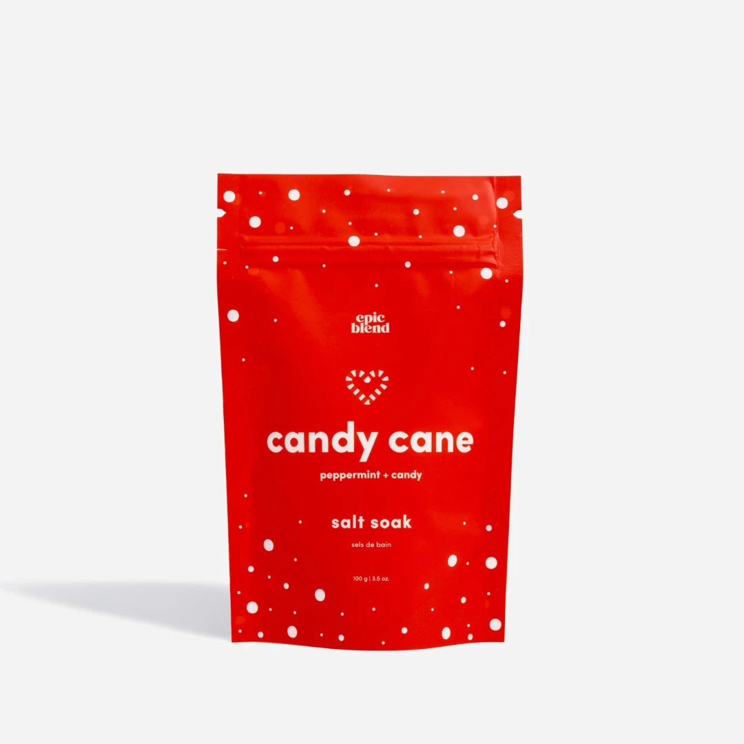 A red pouch of Epic Blend Candy Cane Peppermint Candy Salt Soak. The pouch has a white zipper and is decorated with white dots and candy cane stripes.