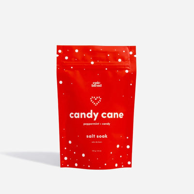 A red pouch of Epic Blend Candy Cane Peppermint Candy Salt Soak. The pouch has a white zipper and is decorated with white dots and candy cane stripes.