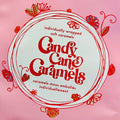 Pink packaging of Candy Cane Caramels with 'pickle and myrrh' branding.