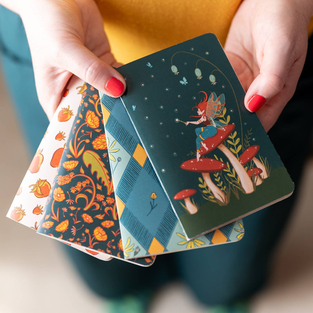 Person holding a deck of cards with colorful designs