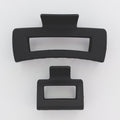 Two black hair clips on a white background
