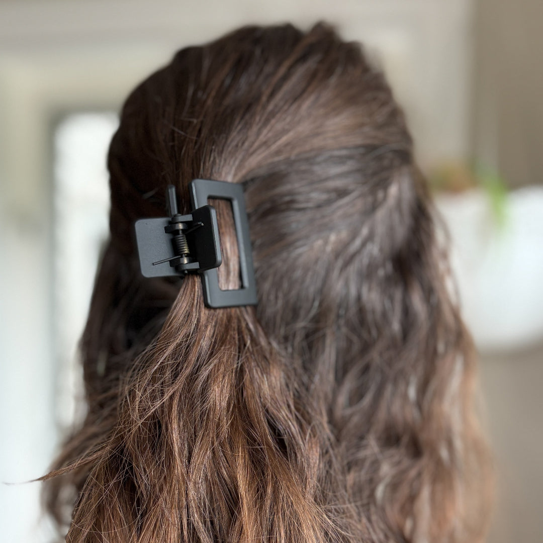 Close-up of a hair clip in a person's hair with a blurred background