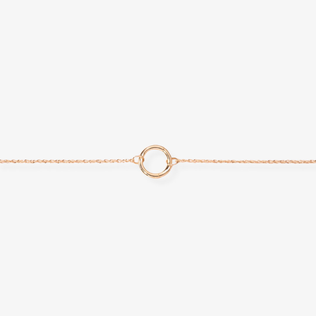 A delicate gold-toned charm necklace with a standard chain, featuring a simple circular charm, possibly Toniq brand, displayed on a white background. This minimalist necklace is available in Ottawa, Ontario, Canada.