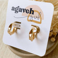Gold hoop earrings on a 'agaveh girl' branded card with dried flowers in the background.