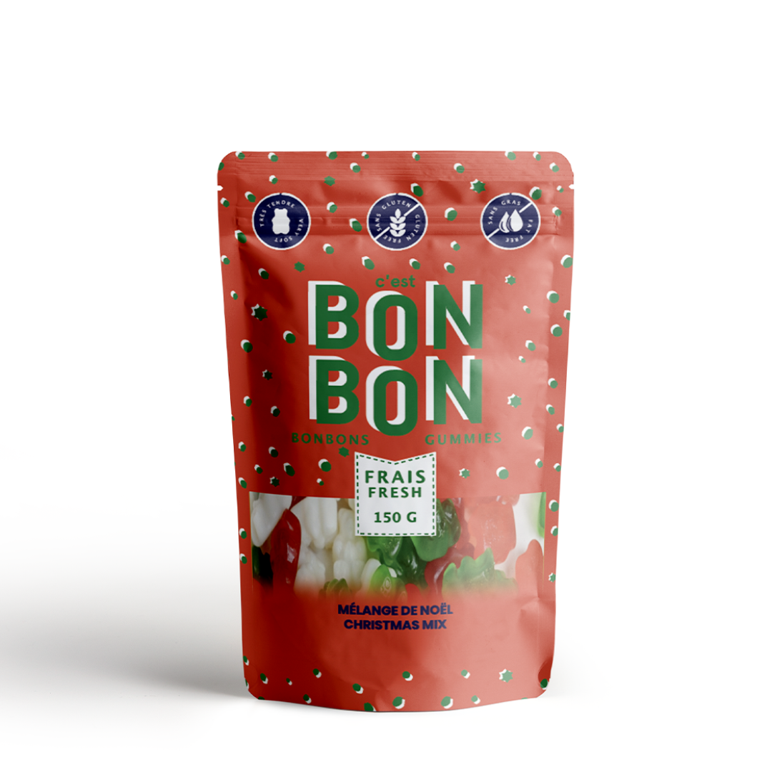 A red, resealable pouch filled with Christmas-themed gummies. The pouch has a transparent window that shows the gummies inside. The label on the pouch is in French and English and reads "BONBON BONBON," "FRAIS FRESH," "150 G," "MÉLANGE DE NOËL," and "CHRISTMAS MIX." There are also icons on the label indicating that the product is gluten-free, vegan, and made in Canada.