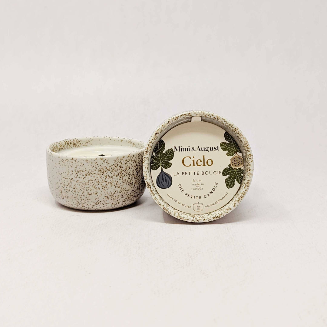 Speckled ceramic candle with a label on a white background