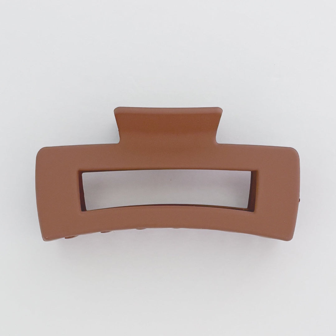 Brown hair clip on a white background