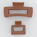 Two brown hair clips on a white background