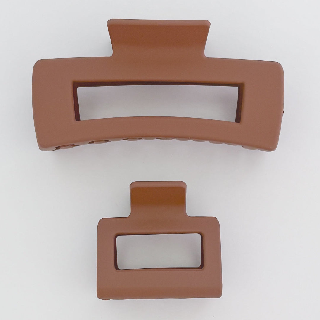 Two brown hair clips on a white background
