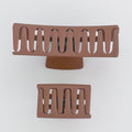 Two brown hair clips on a white background