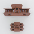 Two brown hair clamps on a white background