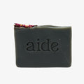 Bar of soap with 'aide' branding on a white background