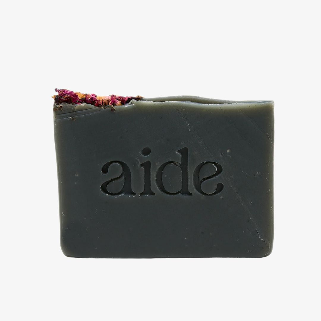 Bar of soap with 'aide' branding on a white background