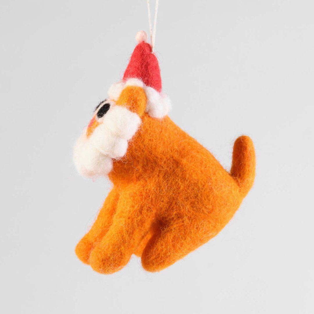 A felt ornament of an orange cat wearing a Santa hat. The cat has a white beard and large black eyes.