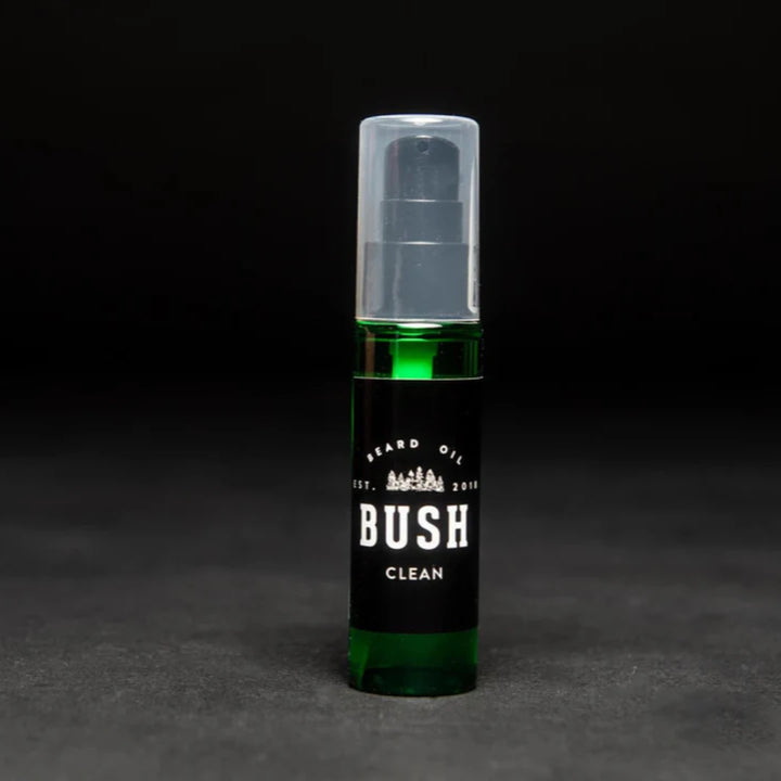 A dark green glass bottle with a black pump dispenser. The bottle is labeled 