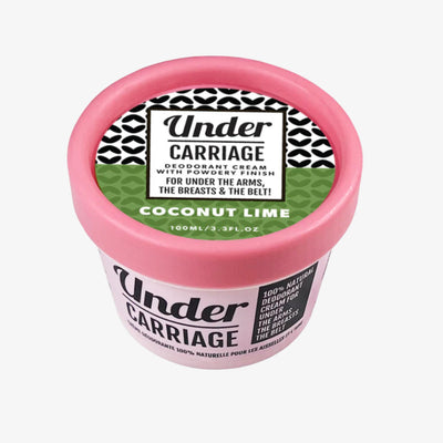 Pink container of Under Carriage deodorant cream with a black and white label on a white background