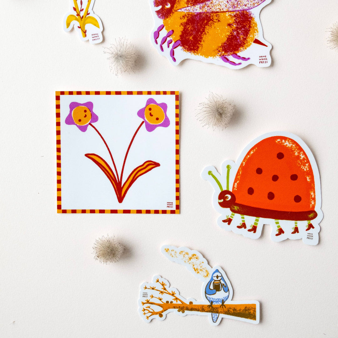 Colorful children's stickers of a bee, flower, ladybug, and caterpillar on a light background.