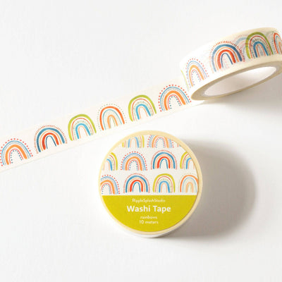 Roll of washi tape with rainbow design on a white background