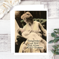 Vintage-style photo of a woman holding a baby with text on a wooden surface.