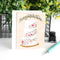 A congratulations card featuring a three-tiered wedding cake decorated with colorful flowers. The word 